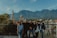 Smiling travelers enjoying a scenic mountain view during a group adventure tour.