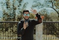 man in black long sleeve shirt wearing black sunglasses