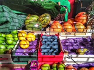 Colorful imported tropical fruits arranged in wooden crates with natural lighting.