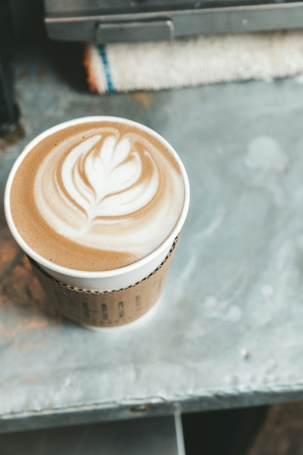 white and brown coffee cup