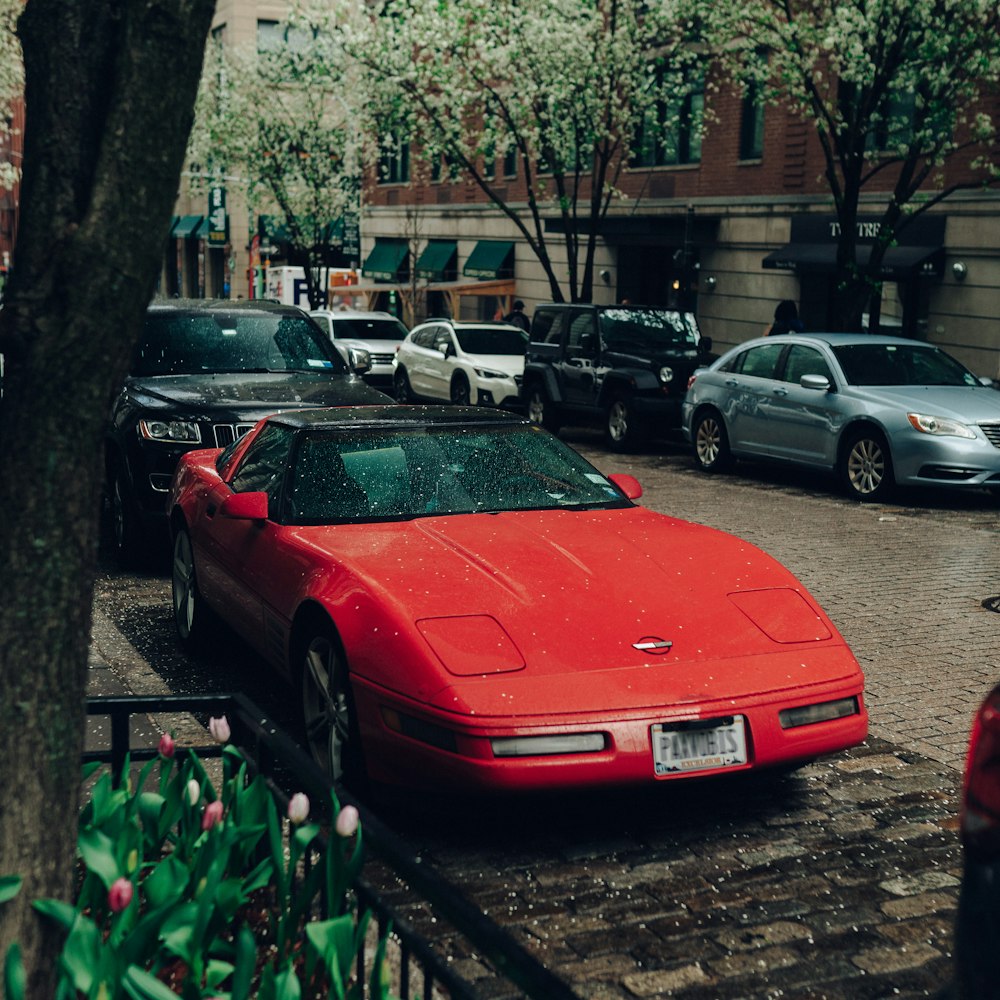 red porsche 911 parked on sidewalk during daytime