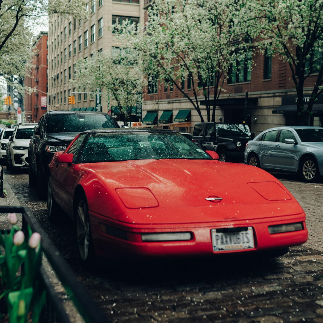red ferrari car parked on sidewalk during daytime