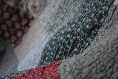 Close-up of a soft, hand-stitched quilt in warm earth tones.