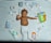 A baby lies on a white quilt surrounded by various baby care products, such as lotions, baby oil, and diapers. The baby is wearing a white diaper with colorful hair ties scattered around. Bright packaging and diverse product shapes create an organized composition.