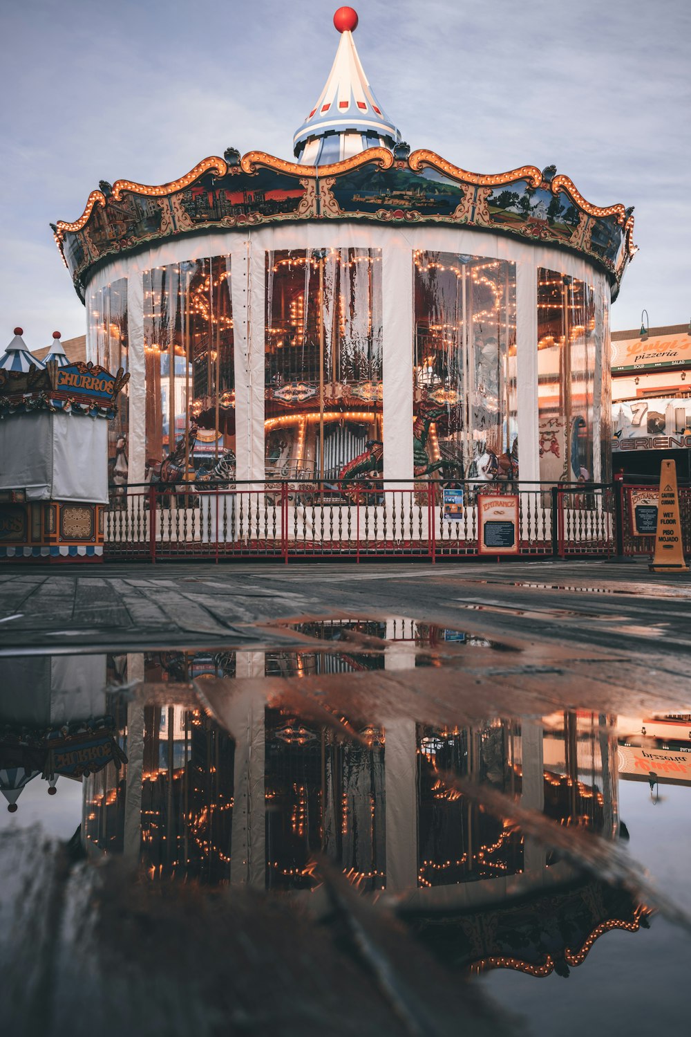 brown and white carousel on a city during night time