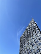 A modern institutional building framed by steel beams under clear skies.