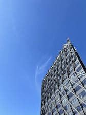 A modern institutional building framed by steel beams under clear skies.