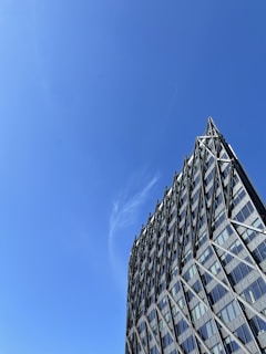 Modern building framework under clear blue sky.