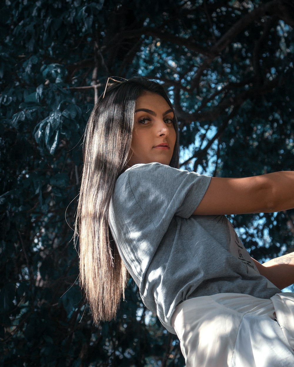 woman in gray t-shirt sitting on ground