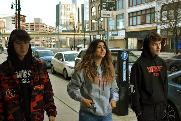 A group of friends in colorful hoodies enjoying the city streets.
