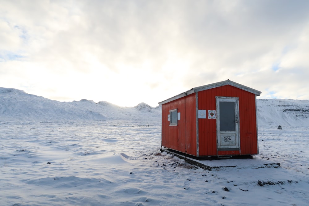 red and white wooden house on body of water during daytime