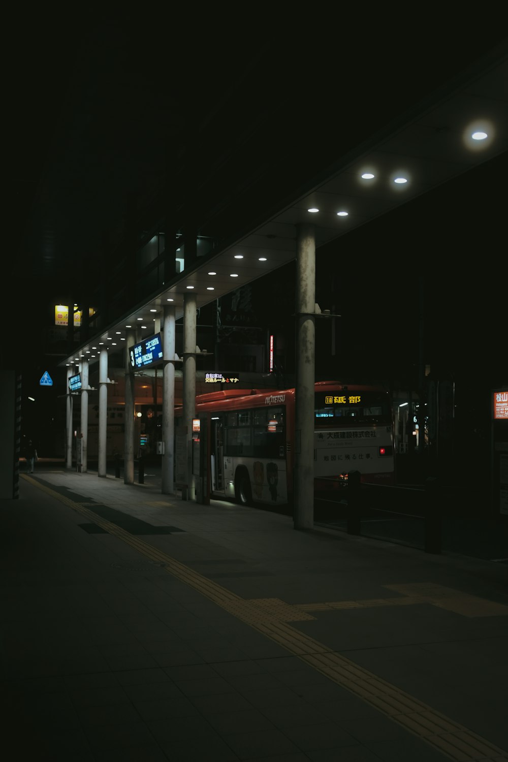 white and blue bus on road during night time