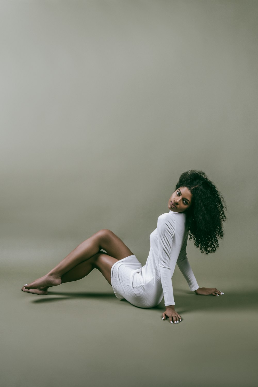 woman in white long sleeve shirt sitting on floor