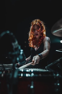 woman in black long sleeve shirt playing piano