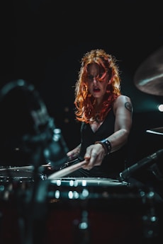 woman in black long sleeve shirt playing piano