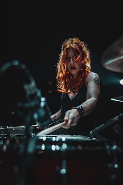 woman in black long sleeve shirt playing piano