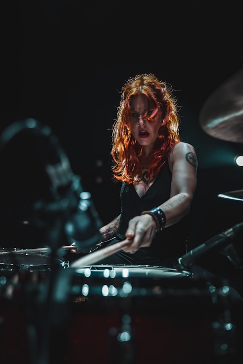 woman in black long sleeve shirt playing piano