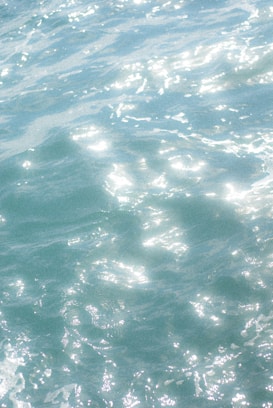 Gentle waves with shimmering reflections on the surface, creating a calming and serene effect.