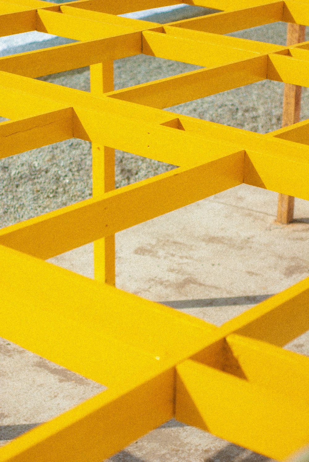 yellow metal railings on white sand during daytime