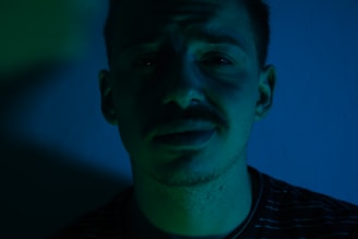 Portrait of Dr. Diego Gino in a calm, professional setting with aqua green and white tones.