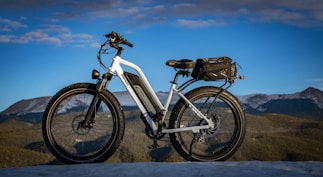 white and black mountain bike on brown field during daytime