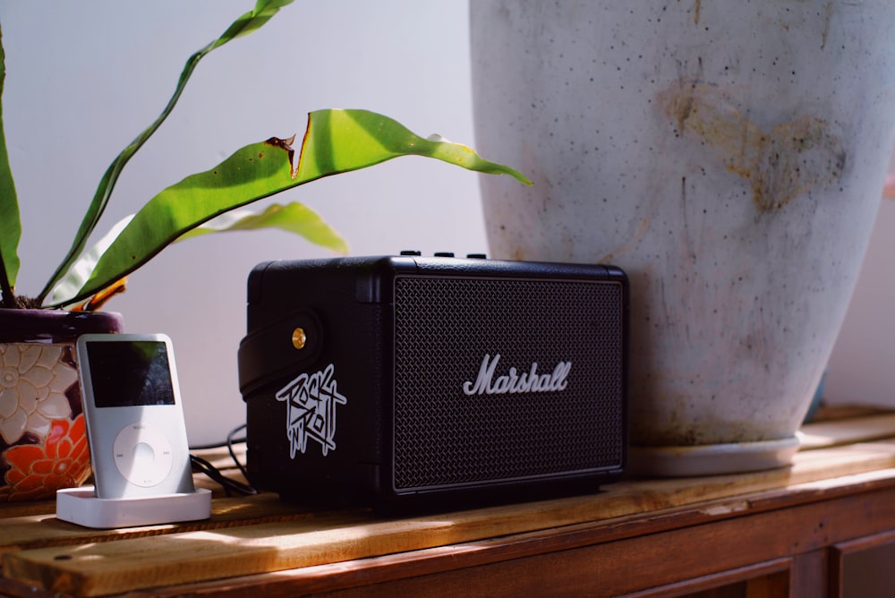 black speaker on brown wooden table