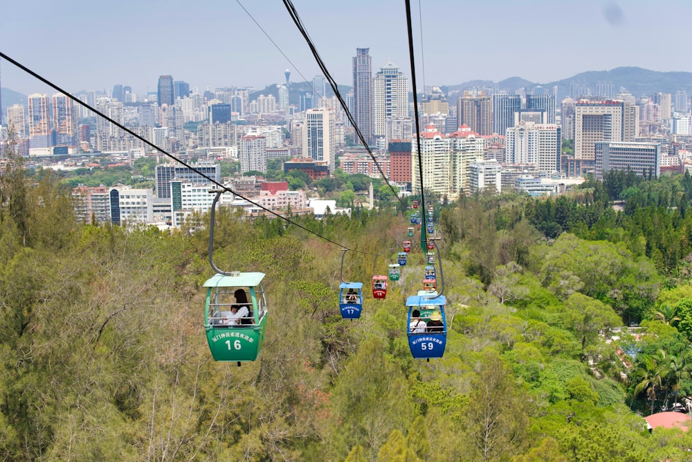 blue cable cars over city buildings during daytime