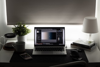 black and silver laptop computer on brown wooden table