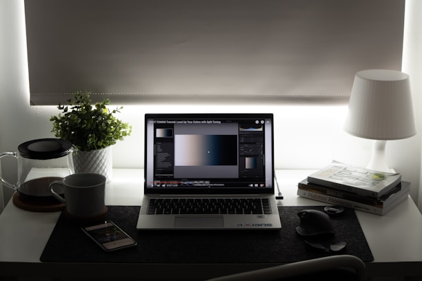 black and silver laptop computer on brown wooden table