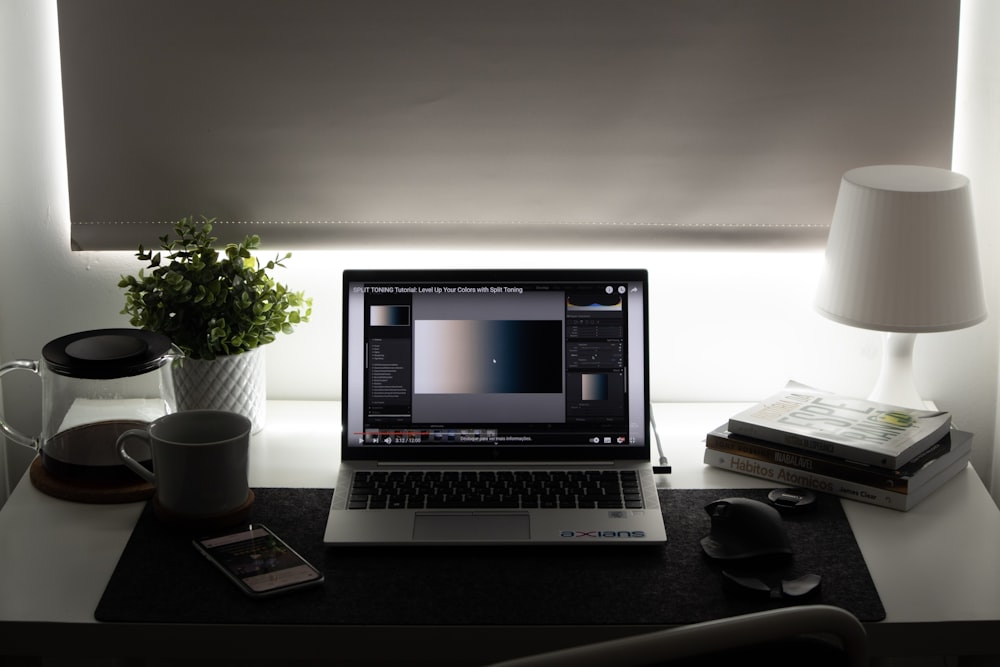 black and silver laptop computer on brown wooden table