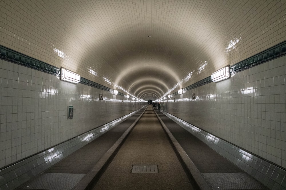 white and brown hallway with lights turned on in the middle