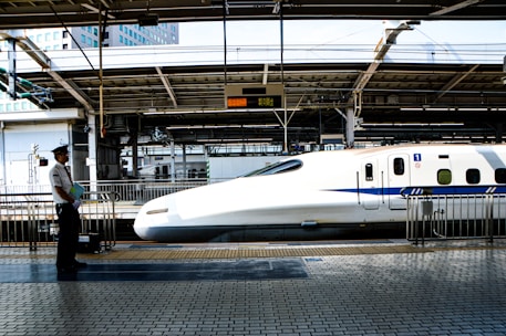 white bullet train on train station