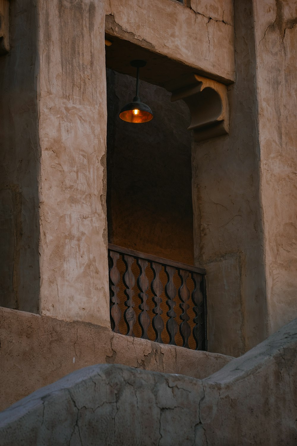 brown wooden balustrade on brown concrete wall