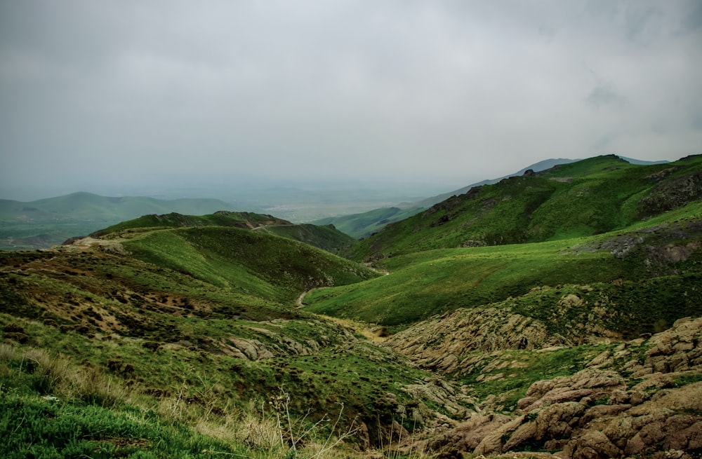 green and brown mountains under white clouds during daytime