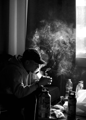 man in white dress shirt smoking cigarette