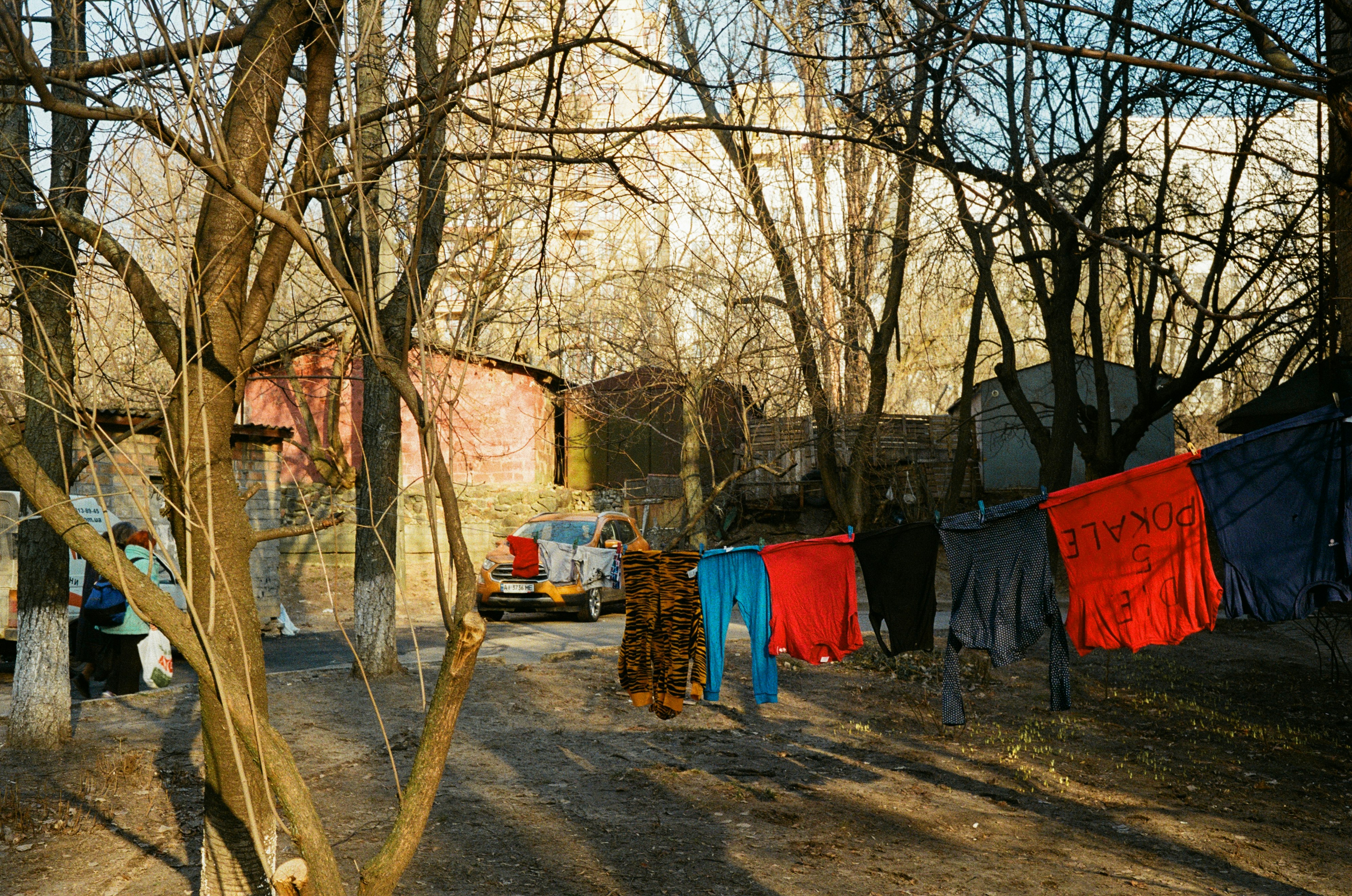 red and blue textile hanged on brown wooden post