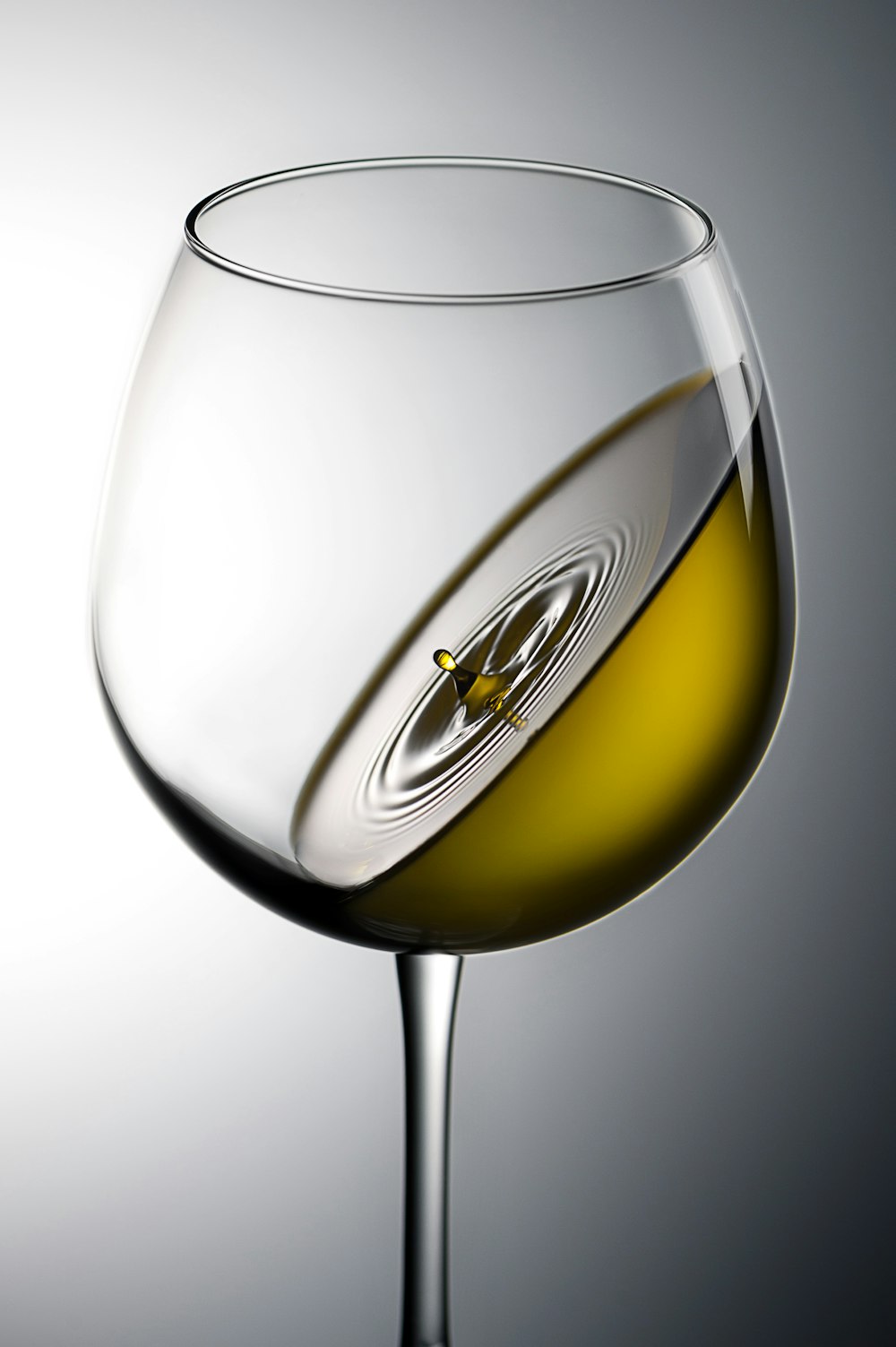 clear wine glass with yellow liquid