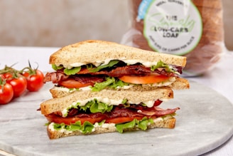 burger with tomato and lettuce on white ceramic plate