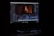 A computer monitor displays video editing software with a video track on the timeline. The screen shows various editing tools and a preview of a video featuring a person with red lighting.