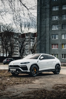 white lamborgini urus on michelin tyres near a nigerian tire shop