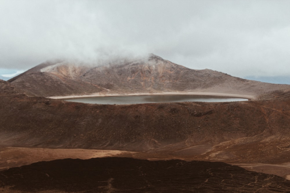 brown mountain under white clouds during daytime