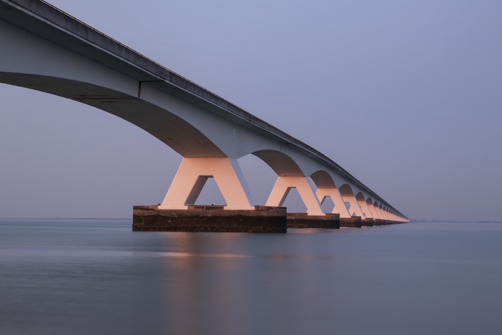 white bridge over body of water