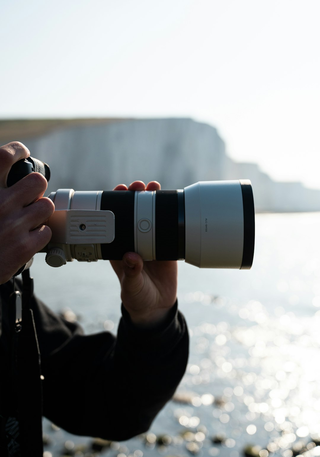 person holding black and white binoculars