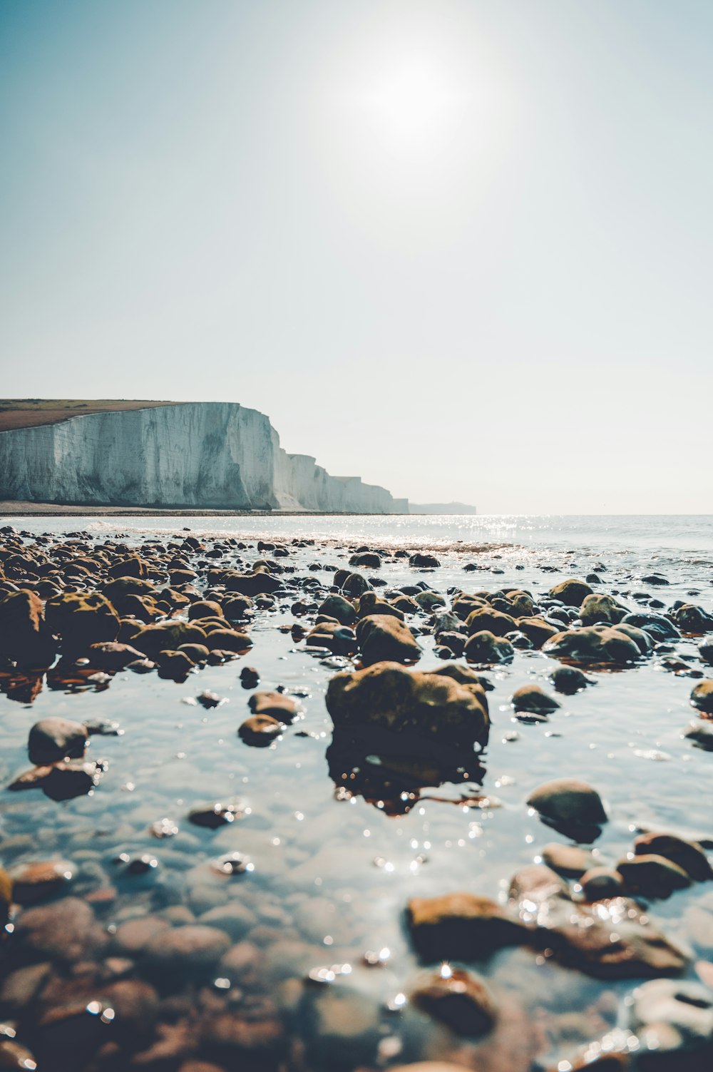 black rocks on seashore during daytime