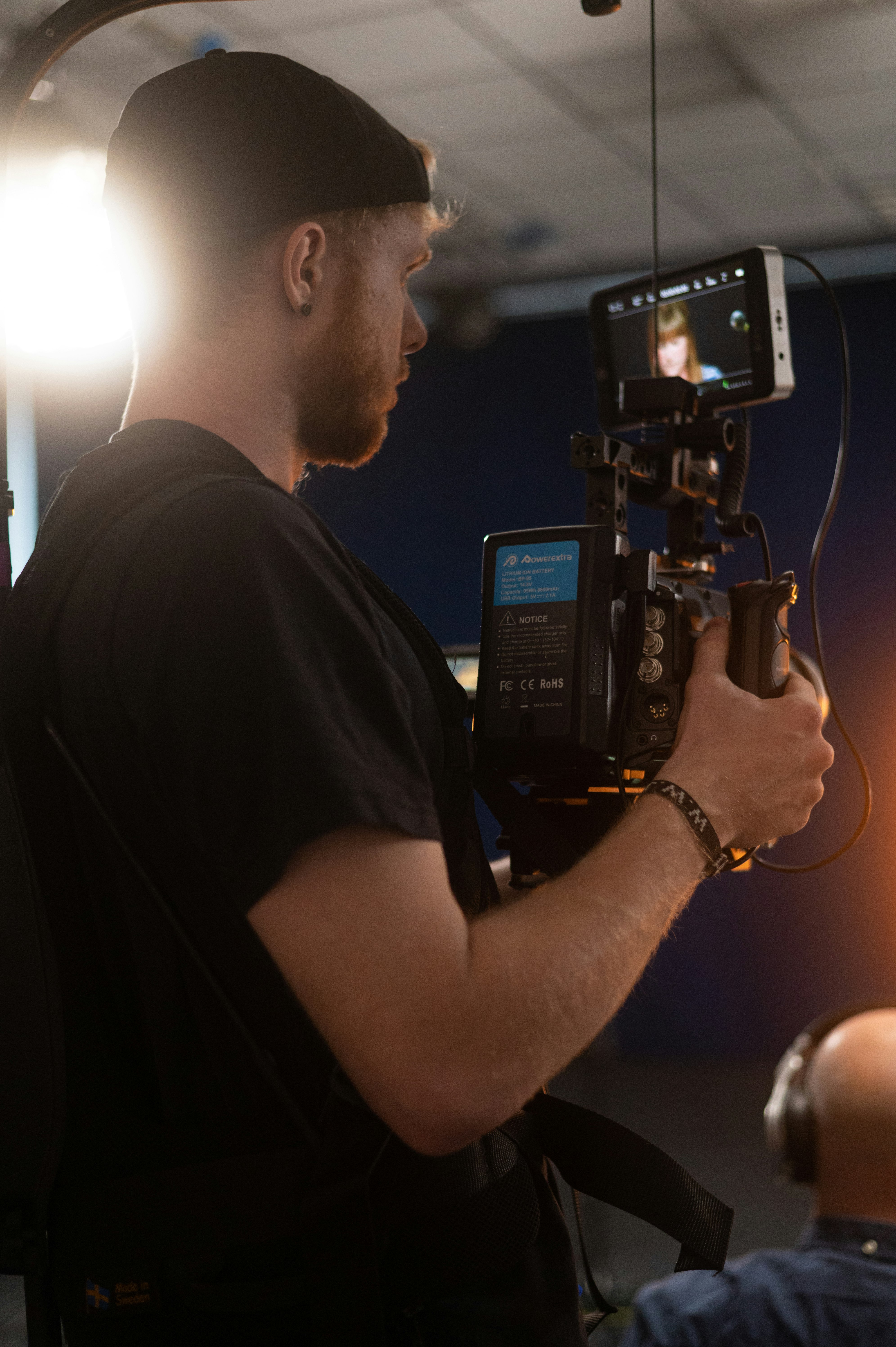 man in black t-shirt holding black video camera