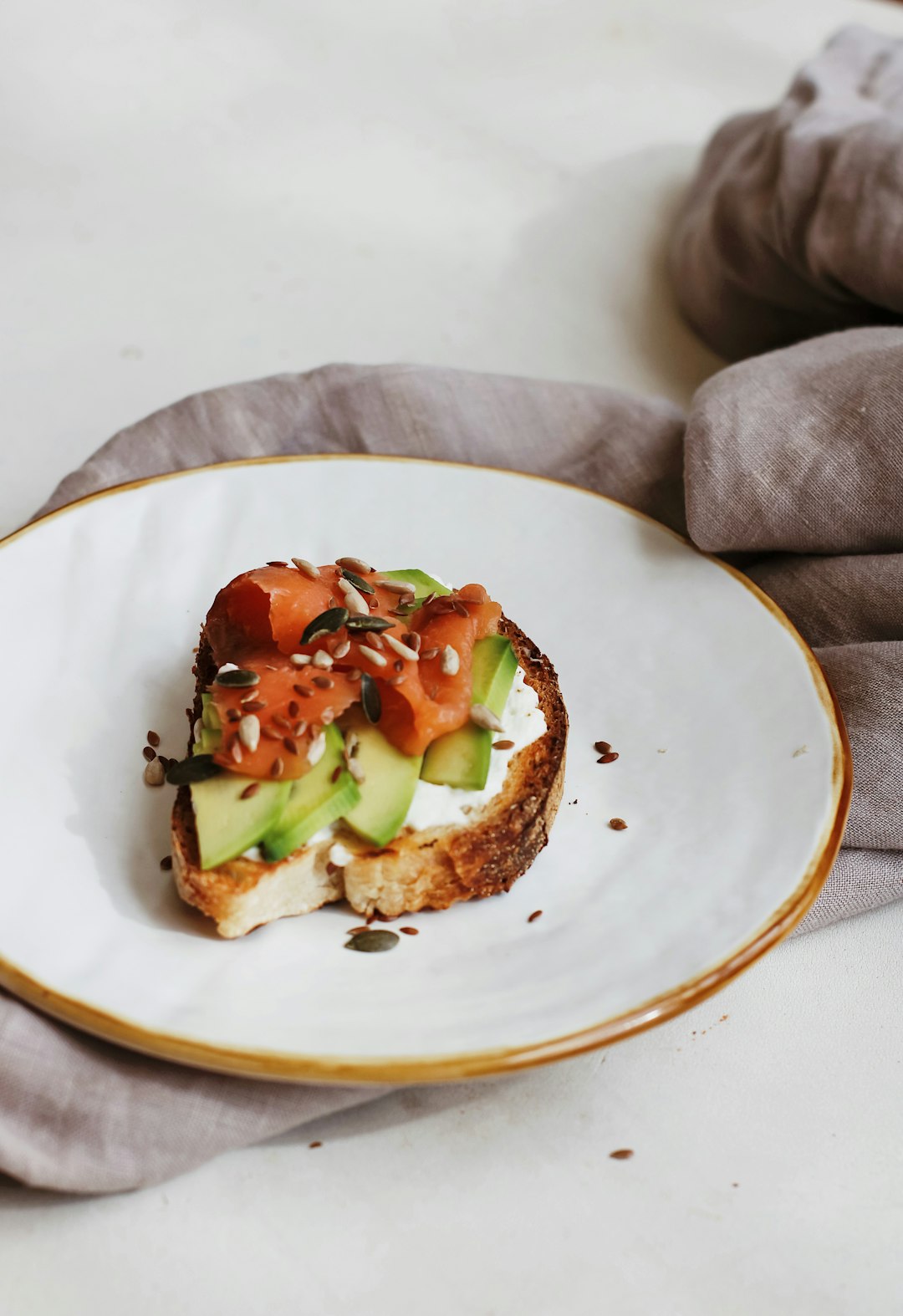 brown bread with green vegetable on white ceramic plate