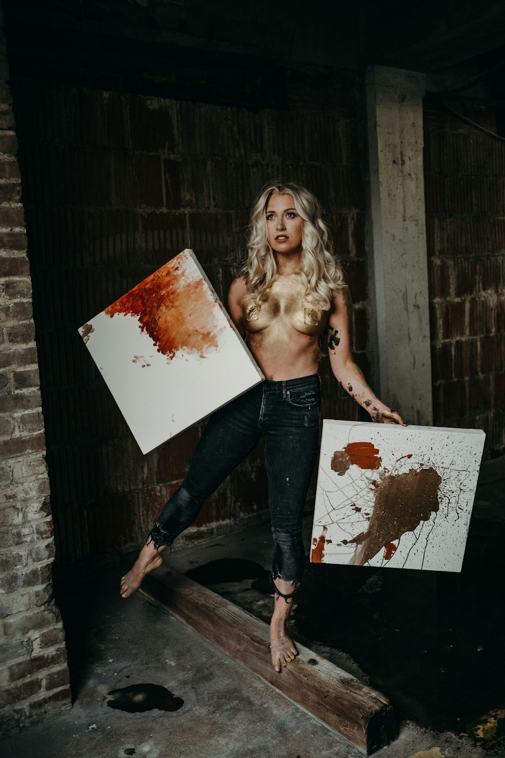 woman in black denim jeans holding white board