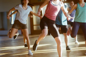 group of women running on brown wooden floor