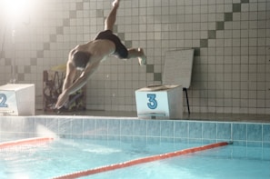 A stunning photo of a swimmer diving into the pool.