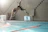 Young athlete diving into the pool during a water polo practice session.